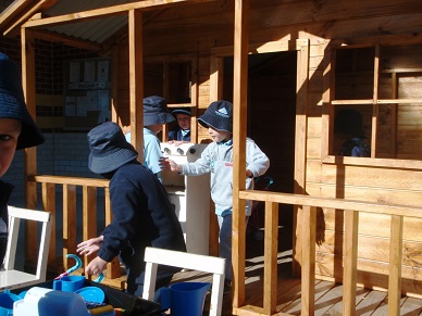 students playing in a cubby house